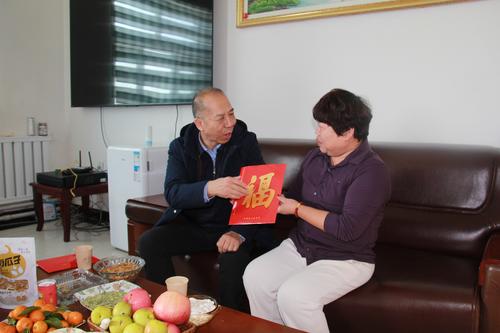 兵团总工会党组成员、副主席黄少峰给183团劳动模范张丽华送慰问金和对联