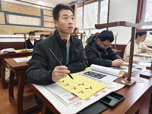 一八二团书法爱好者认真学习书法